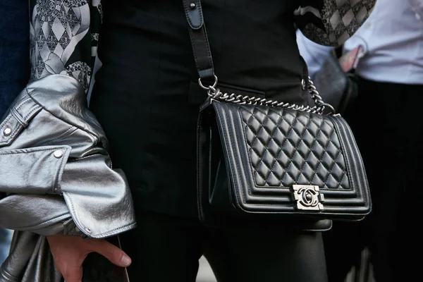 Wanita dengan tas kulit hitam Chanel dan jaket kulit perak sebelum peragaan busana Giorgio Armani, Milan Fashion Week street style pada 22 September 2017 di Milan . — Stok Foto
