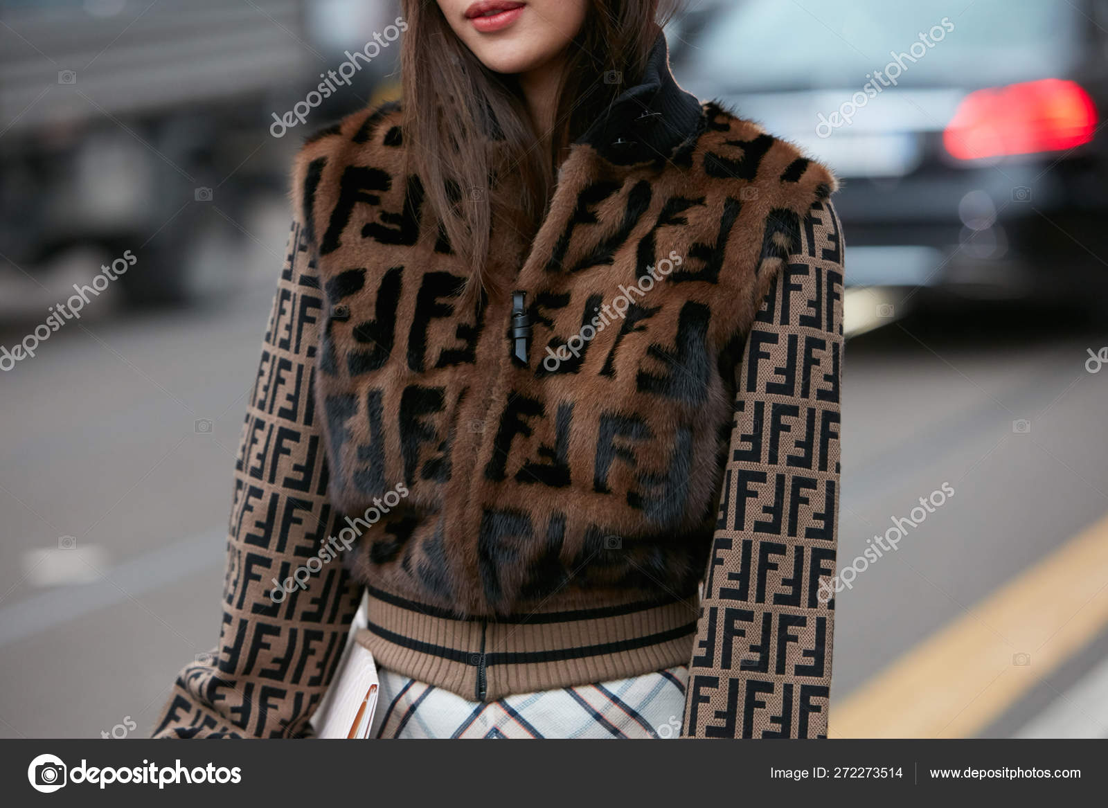 MILAN - FEBRUARY 22: Woman with brown fur jacket with Fendi logo