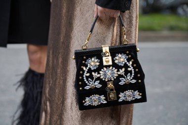 MILAN - FEBRUARY 21: Woman with black Dolce and Gabbana bag with clipart