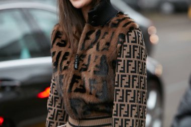 MILAN - FEBRUARY 22: Woman with brown fur jacket with Fendi logo