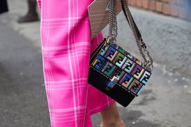 MILAN - FEBRUARY 22: Woman with colorful Fendi bag with logos an