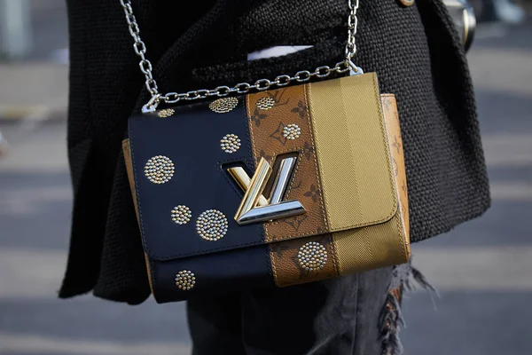 Perempuan dengan krem, coklat dan biru Tas Louis Vuitton dengan logo emas dan perak sebelum peragaan busana Gucci, Milan Mode Week gaya jalan pada 21 Februari 2018 di Milan . — Stok Foto