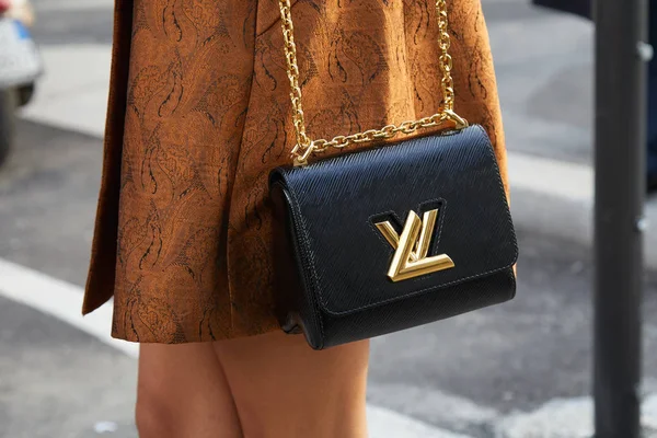 Женщина с черной сумкой Louis Vuitton с золотым логотипом и коричневой курткой перед показом мод Gucci, стиль улицы Milan Fashion Week 21 февраля 2018 года в Милане . — стоковое фото