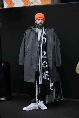 Pal Zileri defilesinden önce turuncu şapkalı ve siyah ceketli adam, 15 Ocak 2018'de Milano Moda Haftası sokak stili Milano'da.