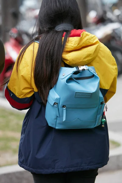 Woman with light blue Hunter backpack and yellow and blue jacket before Giorgio Armani fashion show, Milan Fashion Week street style on January 15, 2018 in Milan. — 스톡 사진