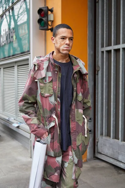ジョルジオ・アルマーニのファッションショーの前に緑、灰色、濃い赤の迷彩ジャケットとズボンを持つ男、ミラノで1月15、2018のミラノファッションウィークストリートスタイル. — ストック写真