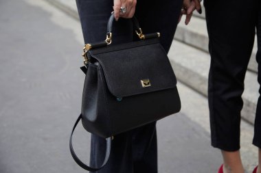 Frankie Morello moda defilesinden önce siyah deri Dolce ve Gabbana çantalı bir kadın. Milan Moda Haftası tarzı. 