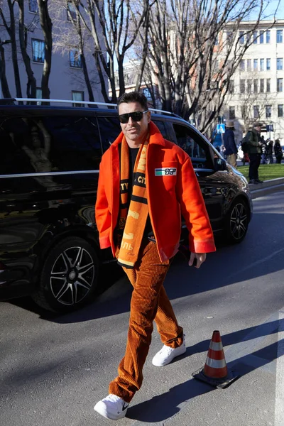 Alex Badia with orange Prada jacket and brown velvet trousers before Emporio Armani fashion show, Milan Fashion Week street style — Stock Photo, Image
