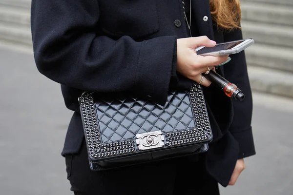 Mujer con bolso de cuero Chanel negro y cigarrillo electrónico mirando el teléfono inteligente antes de Frankie Morello desfile de moda, Milan Fashion Week street style — Foto de Stock