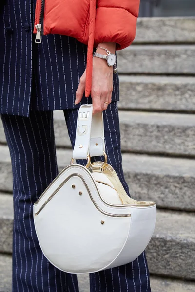 Woman with white and golden leather Genny bag and pinstripe suit before Frankie Morello fashion show, Milan Fashion Week street style — 스톡 사진