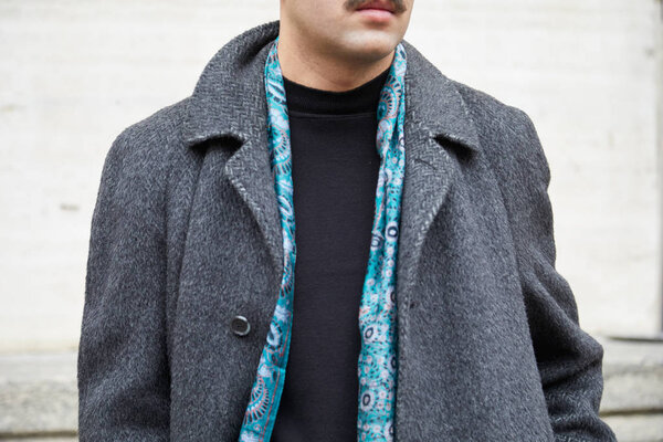 Man with gray coat and blue decorated scarf before Frankie Morello fashion show, Milan Fashion Week street style 