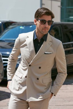 Johannes Huebl salvatore Ferragamo defilesinden önce bej takım elbiseli, Milano Moda Haftası sokak stili 18 Haziran 2017'de Milano'da.