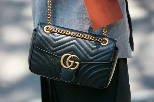 Woman with black Gucci leather bag and chain before Giorgio Armani fashion show, Milan Fashion Week street style on June 19, 2017 in Milan. — Stockfoto