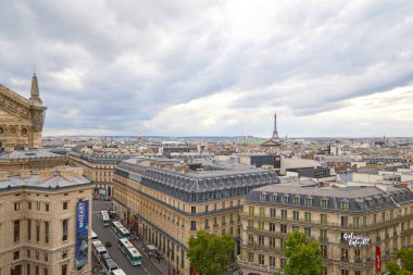 Paris çatıları görünümü ve Eyfel Kulesi Fransa'da bulutlu bir günde Galeries Lafayette terastan görüldü