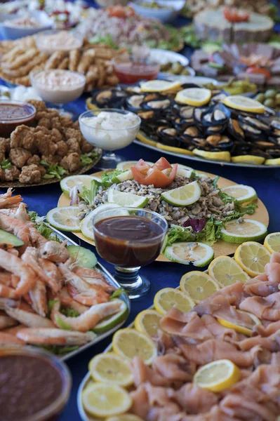 Selection of cold bits, sea food, meat, salads and sauces at a buffet bar, or self-service restaurant. Assorted cold food displayed on individual plates at a wedding, birthday party or banquet.