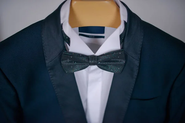 Elegant navy blue suit with white shirt and bow tie, male accessories for formal attire, fashion and beauty concept, classy groom, sophisticated businessman, or sartorial outfit for a job interview