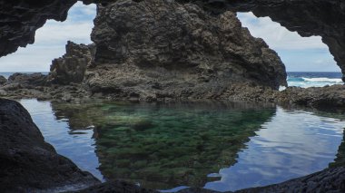 Gözlerden uzak Charco Azul volkanik kristal berraklığında suları Mağarası, doğal bir turkuaz havuzu akan lavlar tarafından oluşturulan ve Atlas Okyanusu'nda El Hierro, kayalardan tarafından izole Kanarya Adaları, İspanya
