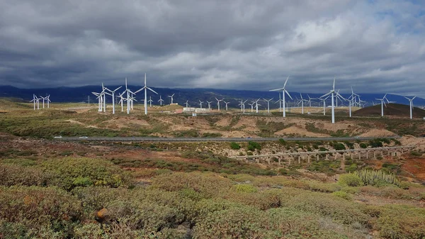 Windmills and photovoltaic panels in the southern part of Tenerife, Canary Islands, producing clean energy, sustainable and eco-friendly solutions to integrate available resources such as sun and wind