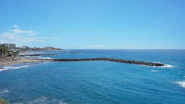 Sunny day in Playa de Las Americas, an lively expansive resort in the south western part of the island, with numerous water attractions, hotels, venues and restaurants, Tenerife, Canary islands, Spain