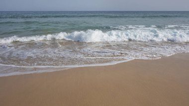 Frothy waves washing the pristine beach Playa Jandia, in Fuerteventura, one of the most attractive tourist destinations in the Canary Islands, for its white sandy beaches, mild climate and wild nature