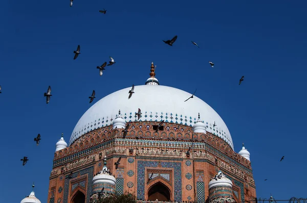 Flying birds over dome of Islamic Shrine