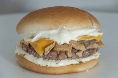 High calories chicken burger with cheese and mushrooms 