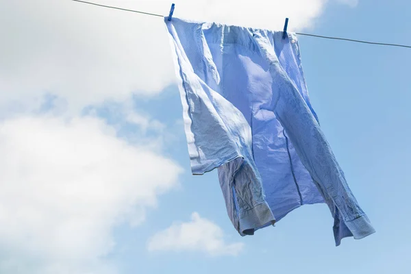 White shirt hanging to dry on clothes line