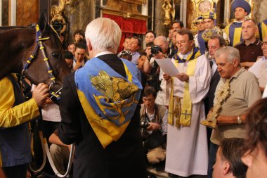 SIENA, ITALY - AUGUST 16, 2008: blessing of a horse before the Palio of Siena, Italy clipart