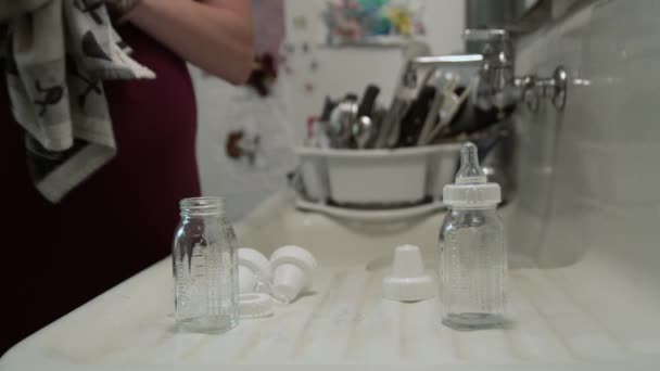 Close Pregnant Woman Drying Baby Bottles — Stock Video