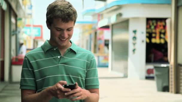 Teenage Boy Using Cellphone Laughing — Stock Video