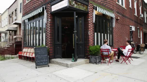 Woman Leaving Coffee House Greeting Men She Walks — Stock Video