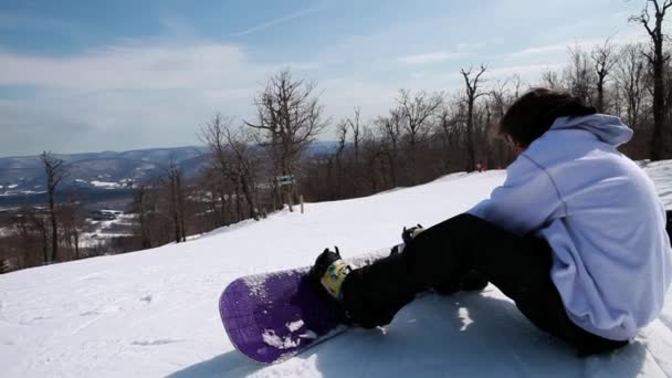 Man Putting Snowboard Snowboarding Downhill — Stock Video