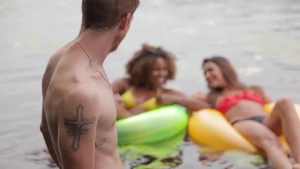 Homem Assistindo Jovens Mulheres Flutuando Anéis Borracha Lago — Vídeo de Stock