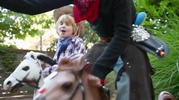 Two Boys Dressed Cowboys Rocking Horses Toy Guns — Stock Video