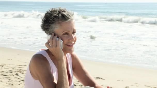 Mulher Sênior Usando Telefone Celular Praia — Vídeo de Stock