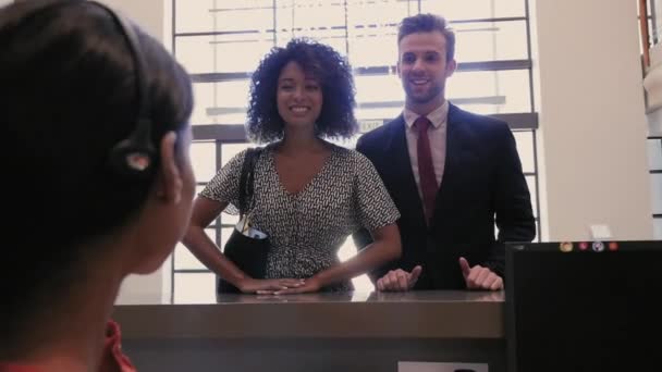 Female Receptionist Pointing Way Visitors — Stock Video