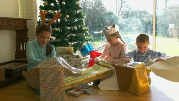 Дівчата Хлопчик Розгортають Подарунки Різдвяною Ялинкою — стокове відео