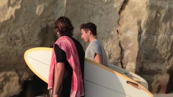 Två Surfare Transporterar Surfbrädor Stranden — Stockvideo
