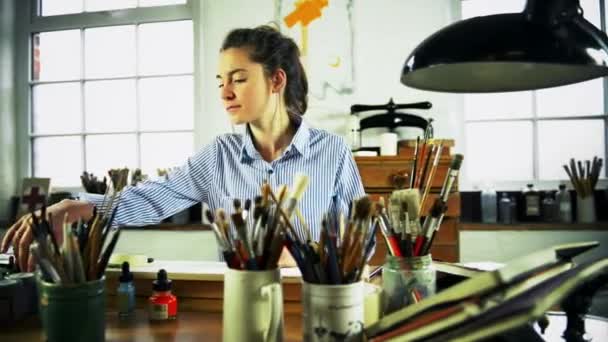 Young Female Artist Arranging Inks Desk — Stock Video