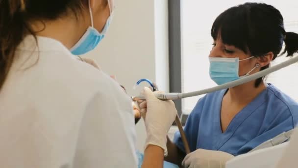 Two Female Dentists Treating Patient — Stock Video