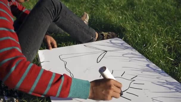 Boy Girl Sitting Grass Drawing Wind Turbine — Stock Video