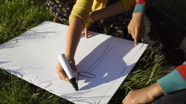 Close Boy Girl Sitting Grass Drawing Wind Turbine — Stock Video