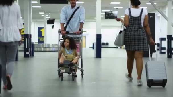 Πατέρας Κόρη Και Γυναίκες Που Περπατούν Τροχοφόρα Αποσκευές Στο Αεροδρόμιο — Αρχείο Βίντεο