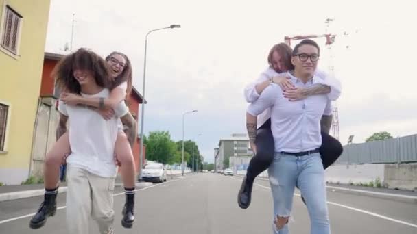 Man Giving Piggy Back Rides Women Street — Stock Video