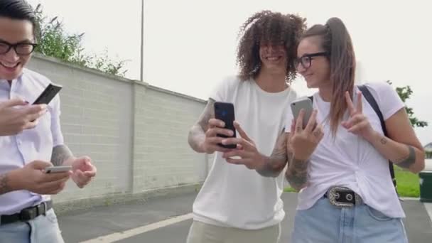 Four Friends Looking Smartphones Outdoors — Stock Video