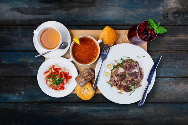 Lunch set. Solyanka, pilaf and tomato salad, served on the tray with the cutlery. — Stock Photo, Image