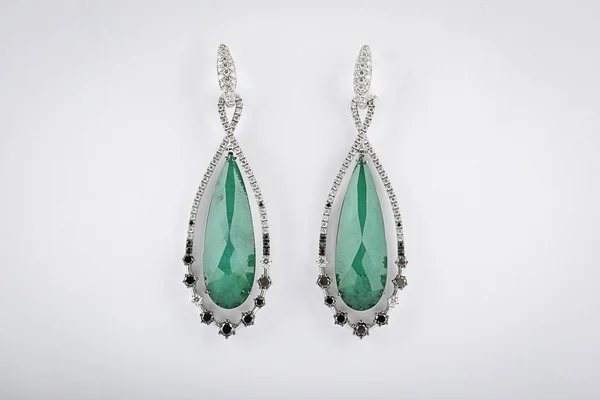 Silberohrringe mit Diamanten für Frauen, grüner Stein in der Mitte in Form eines Tropfens, isoliert auf weißem Hintergrund. — Stockfoto