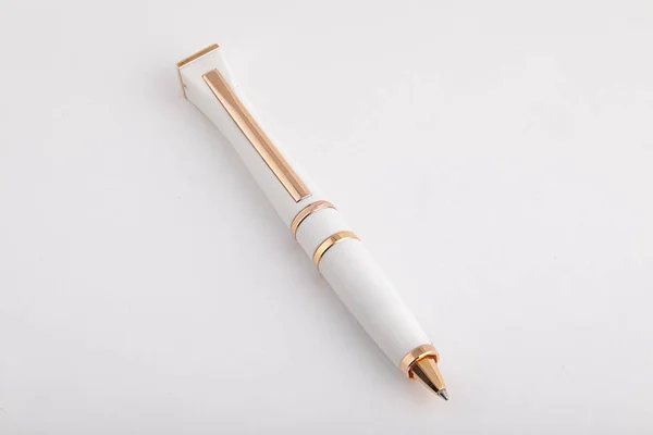 White, ballpoint pen with golden inserts,isolated on white background. — Stock Photo, Image