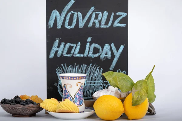 La vacanza di Navruz. Tazza da tè tradizionale armudu con motivi nazionali e stampa buta. Piatto con l'iscrizione la vacanza di Novruz e disegno Samani . — Foto Stock