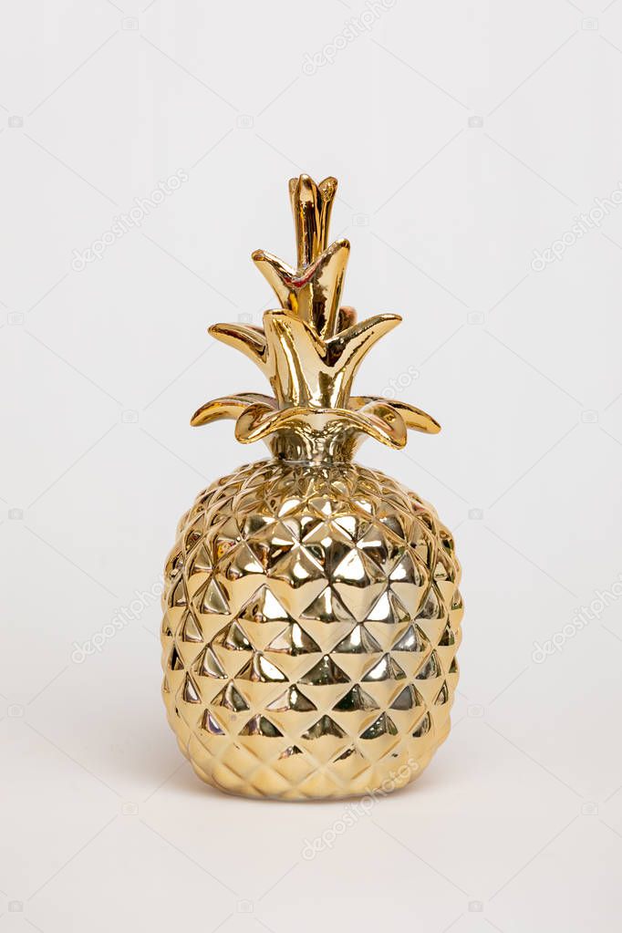 Pineapple figurine, Golden color, isolated on white background. 
